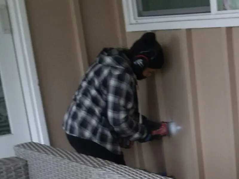 Professional electrician installing an exterior outlet in Lima